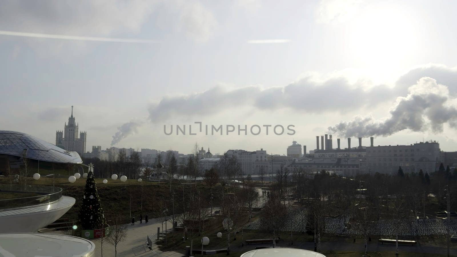 Industrial smokestacks emitting large plumes of smoke over moscow skyline, a concerning scene of urban pollution