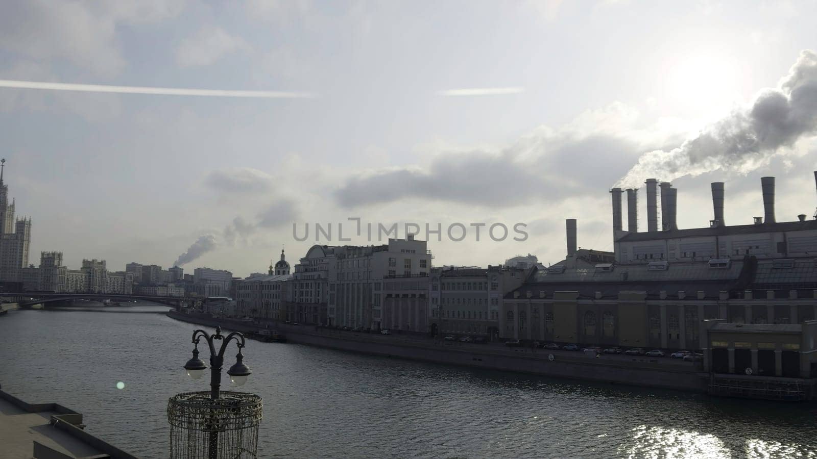 Industrial landscape of moscow with power plant chimneys emitting smoke over moskva river