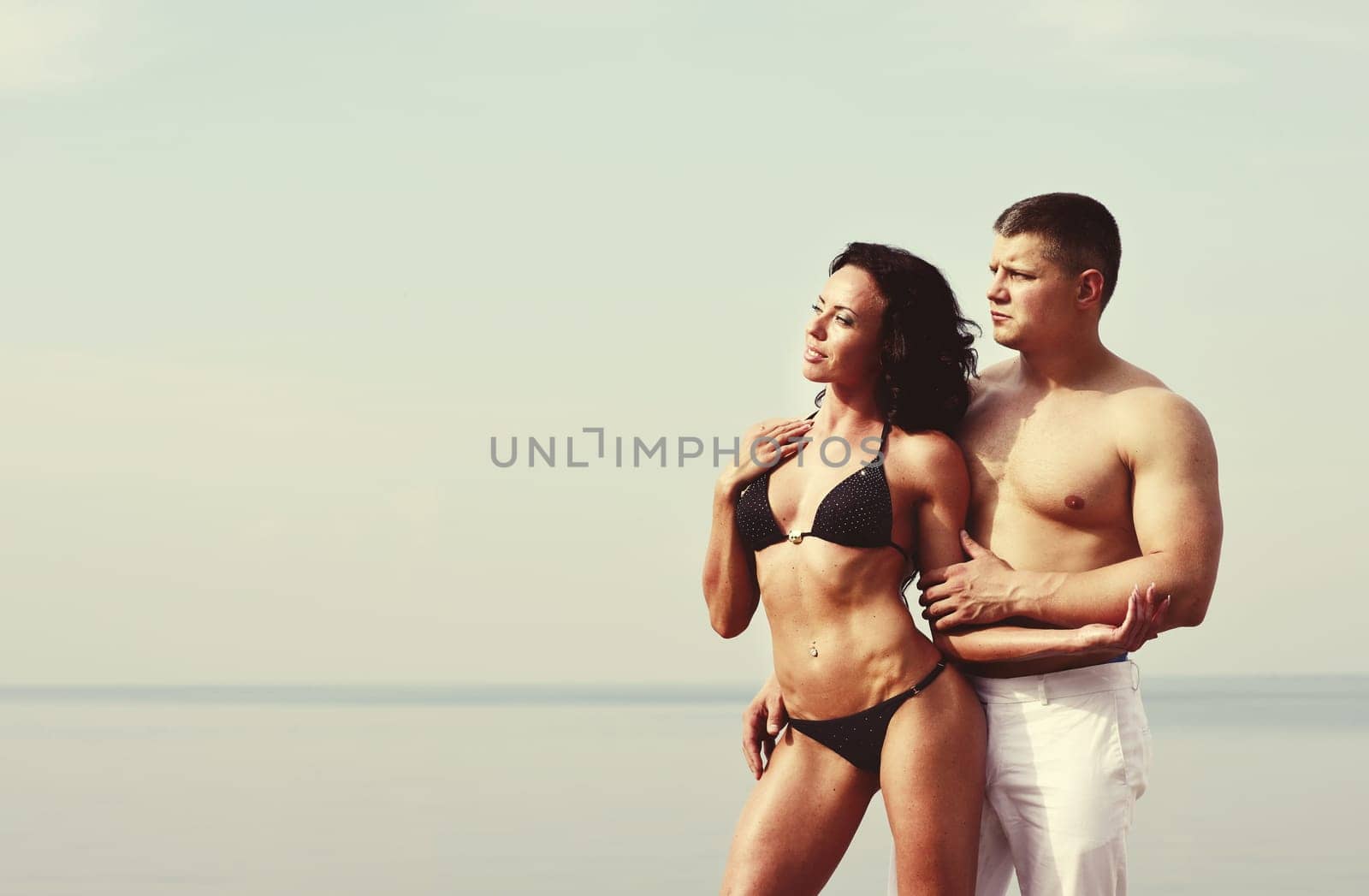 young caucasian couple at the sea side together