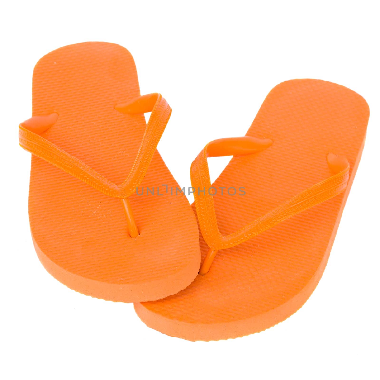 pair of orange sandals isolated on white background