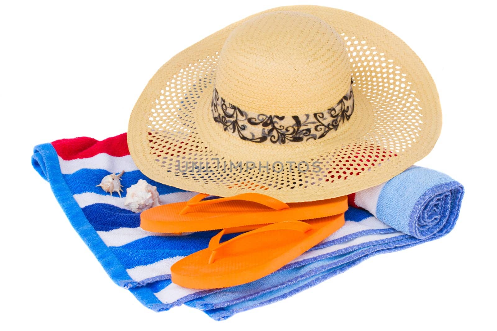 straw hat and beach towel isolated on white background