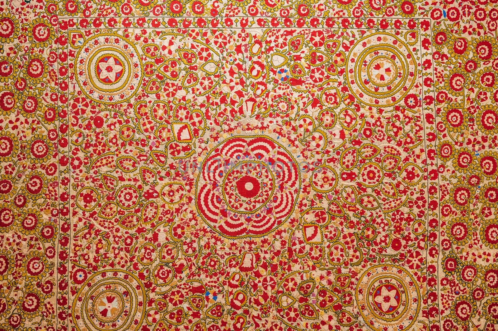 traditional Uzbek pattern on an ancient handmade carpet in Uzbekistan. Oriental background with beautiful ornaments