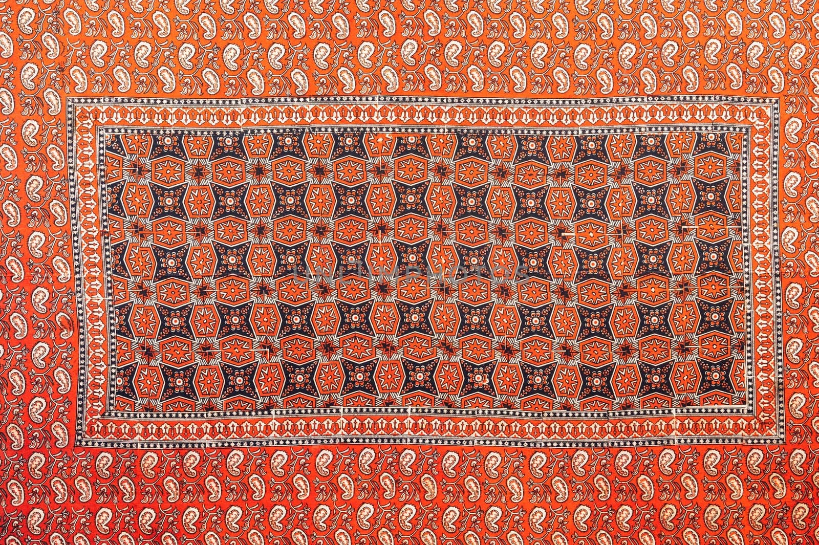 traditional Uzbek geometric pattern on an ancient vintage carpet in Uzbekistan. Oriental background with beautiful ornaments
