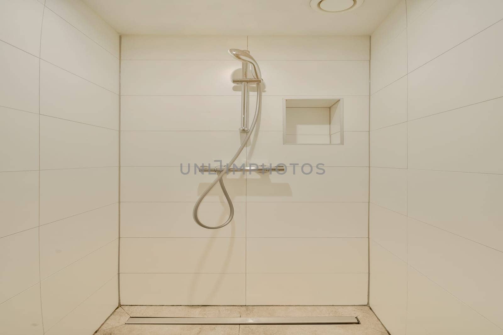 This image features a sleek, minimalist shower design with clean lines, a modern showerhead, and simple tile work, showcasing contemporary bathroom aesthetics.