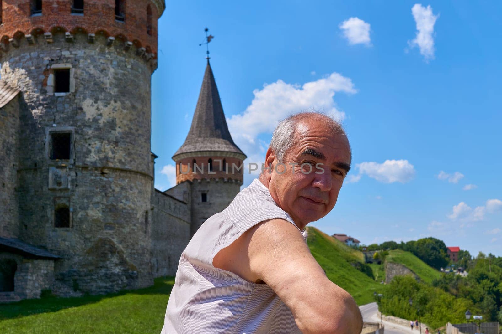 a person who is traveling or visiting a place for pleasure