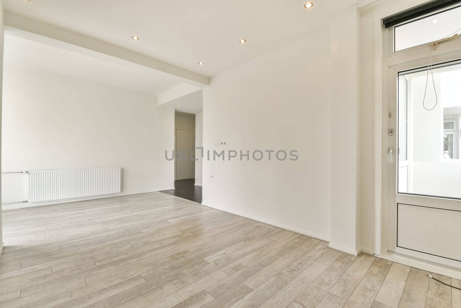 A bright, minimalist interior featuring sleek lines and neutral colors, showcasing an inviting and spacious environment perfect for contemporary living.