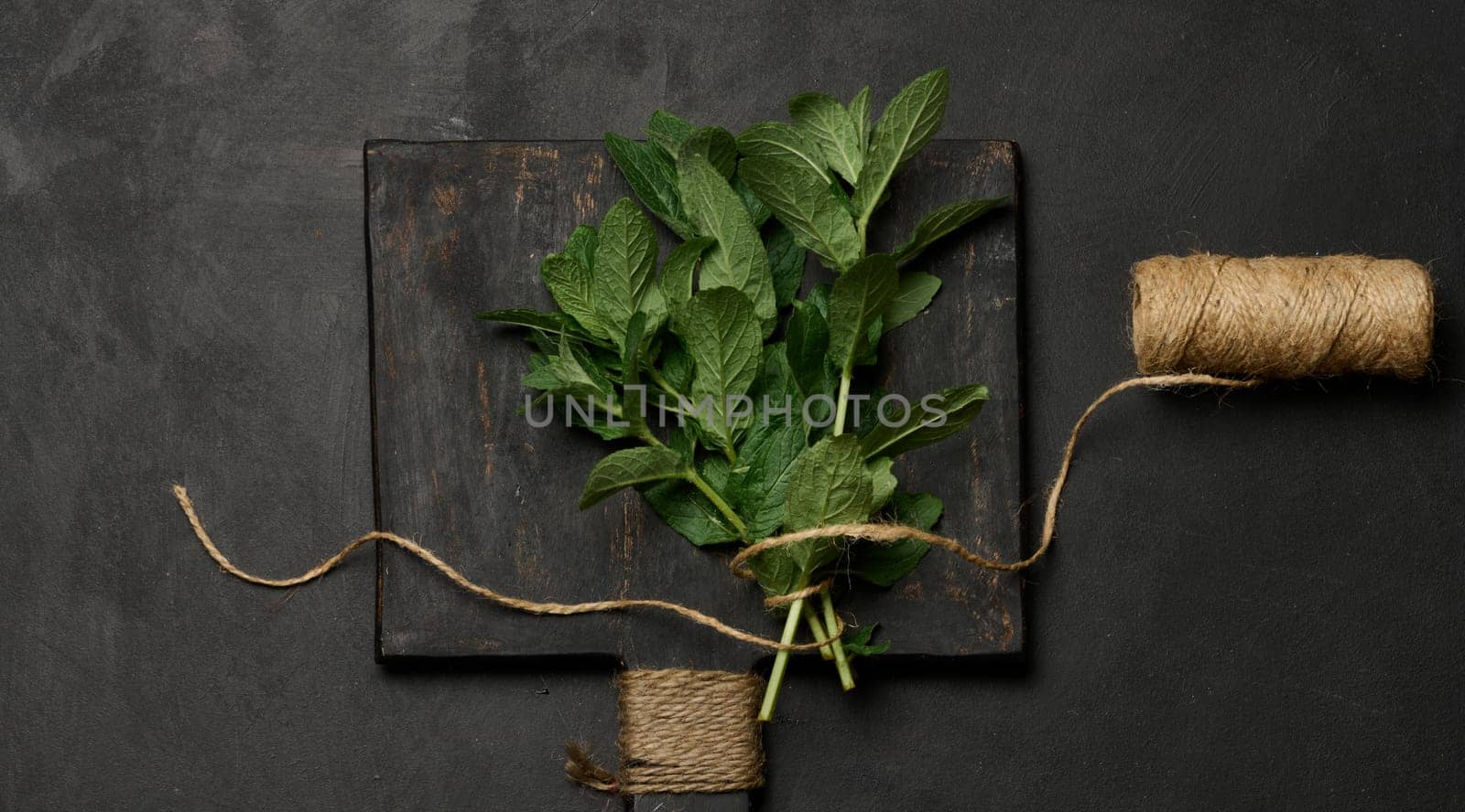 Bunch of fresh green mint on wooden board, top view