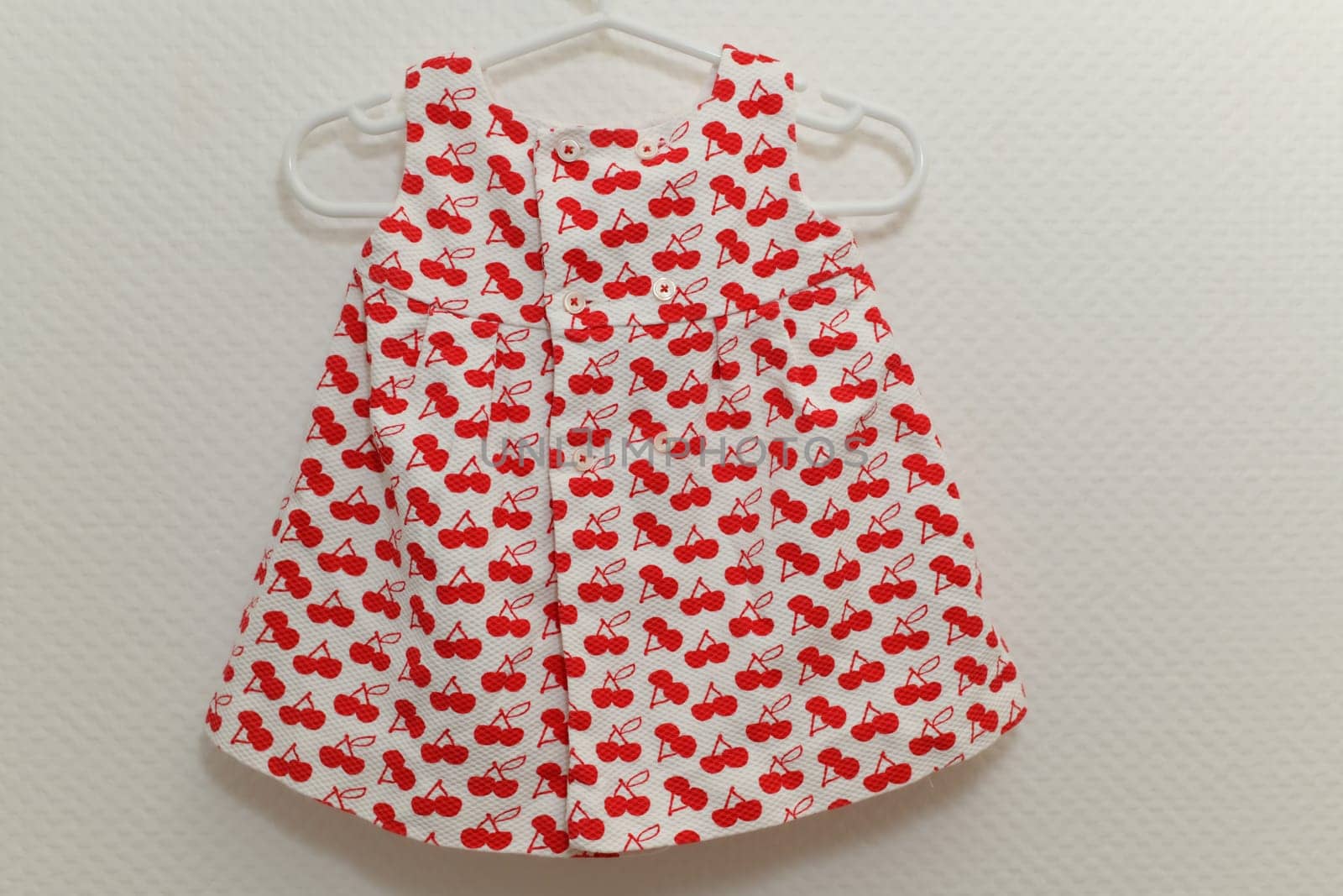 Dress with cherry patterns for girls on white background