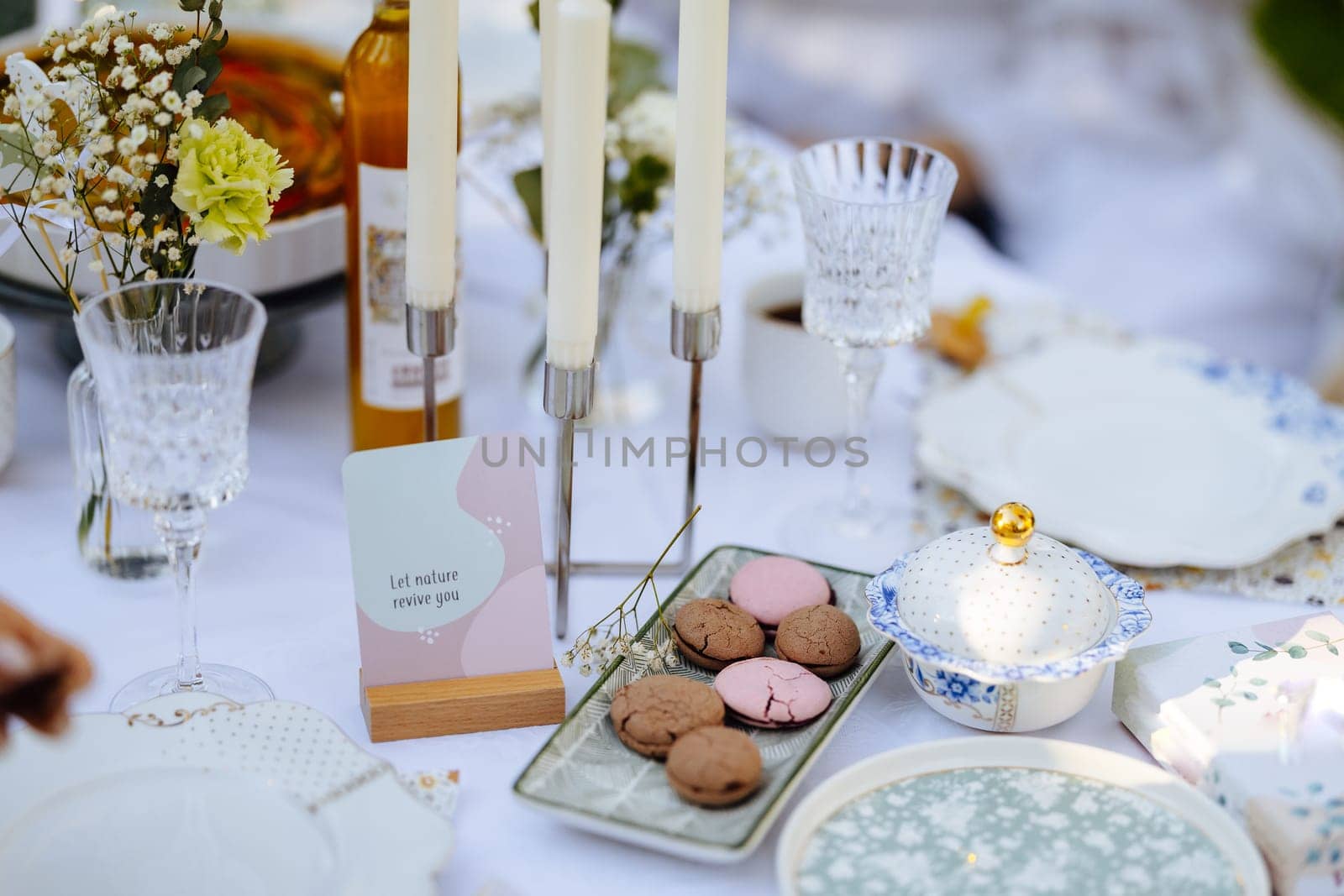 On the table, there are plates arranged neatly, candles flickering softly, and delicious cookies placed temptingly on it