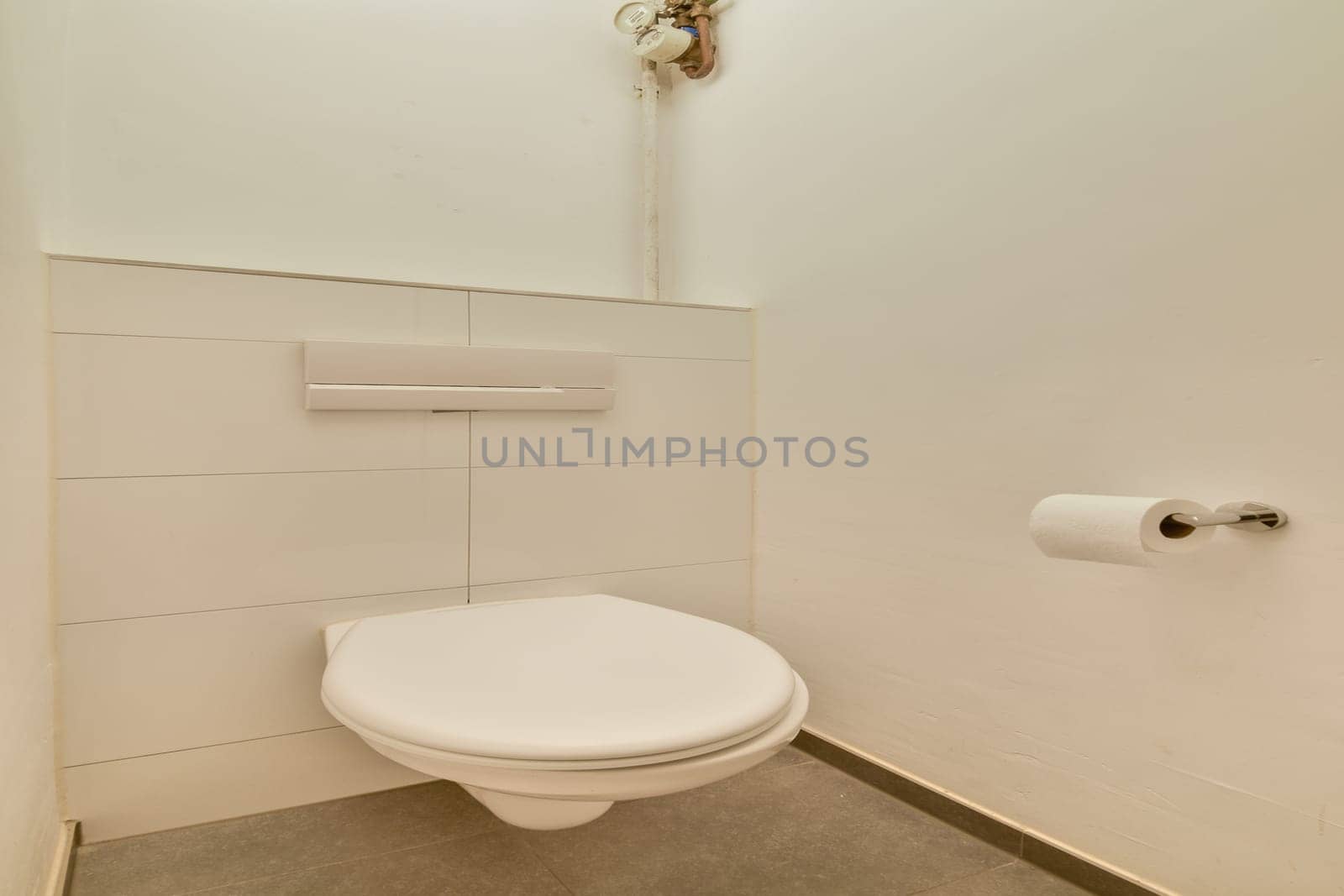 A sleek and modern toilet setup in a minimalist bathroom design, featuring clean lines and neutral tones, ideal for contemporary spaces.