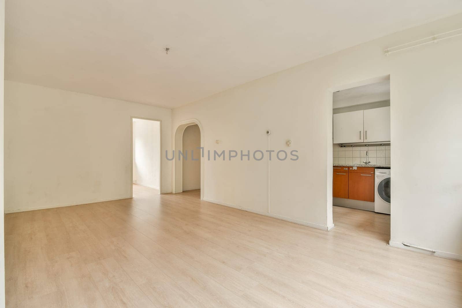 An empty room showcasing a minimalist design, featuring light-colored walls and wooden flooring, ideal for various interior styles or decoration ideas.