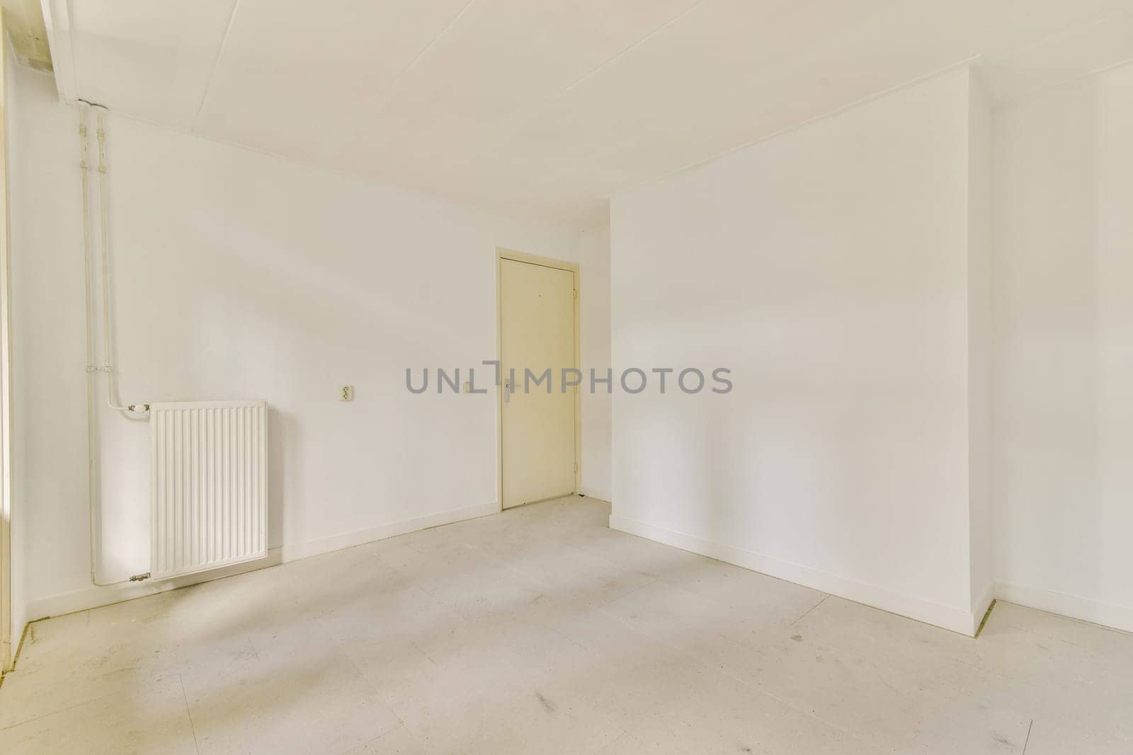 A minimalistic and clean white interior showcasing an empty room with plain walls and flooring, emphasizing simplicity and spaciousness.