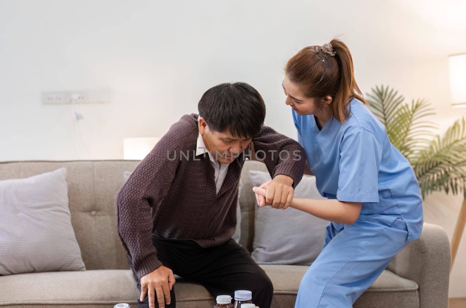 A caregiver helps an elderly man in a cozy home setting, showcasing compassion and support in daily living.