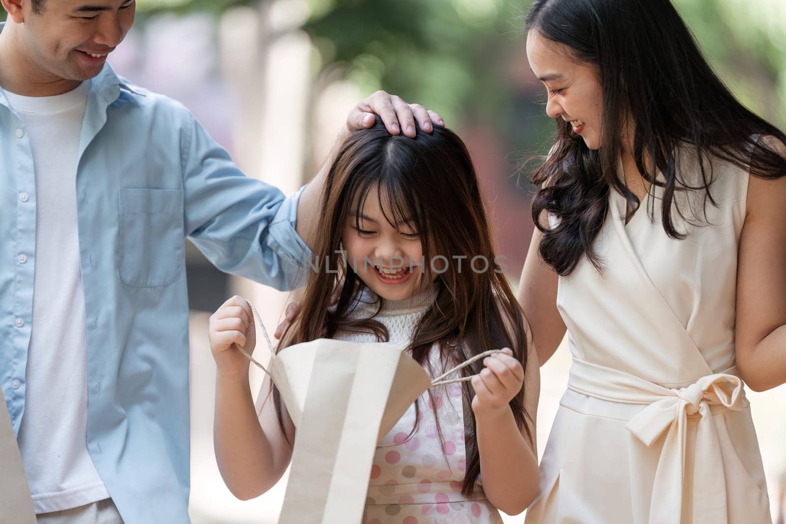 A happy family enjoying a shopping day together, showcasing joy and togetherness with shopping bags and smiles.