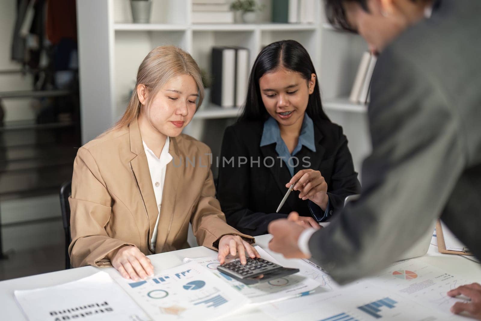 Business professionals collaborate in a meeting, exchanging ideas and strategies for success.