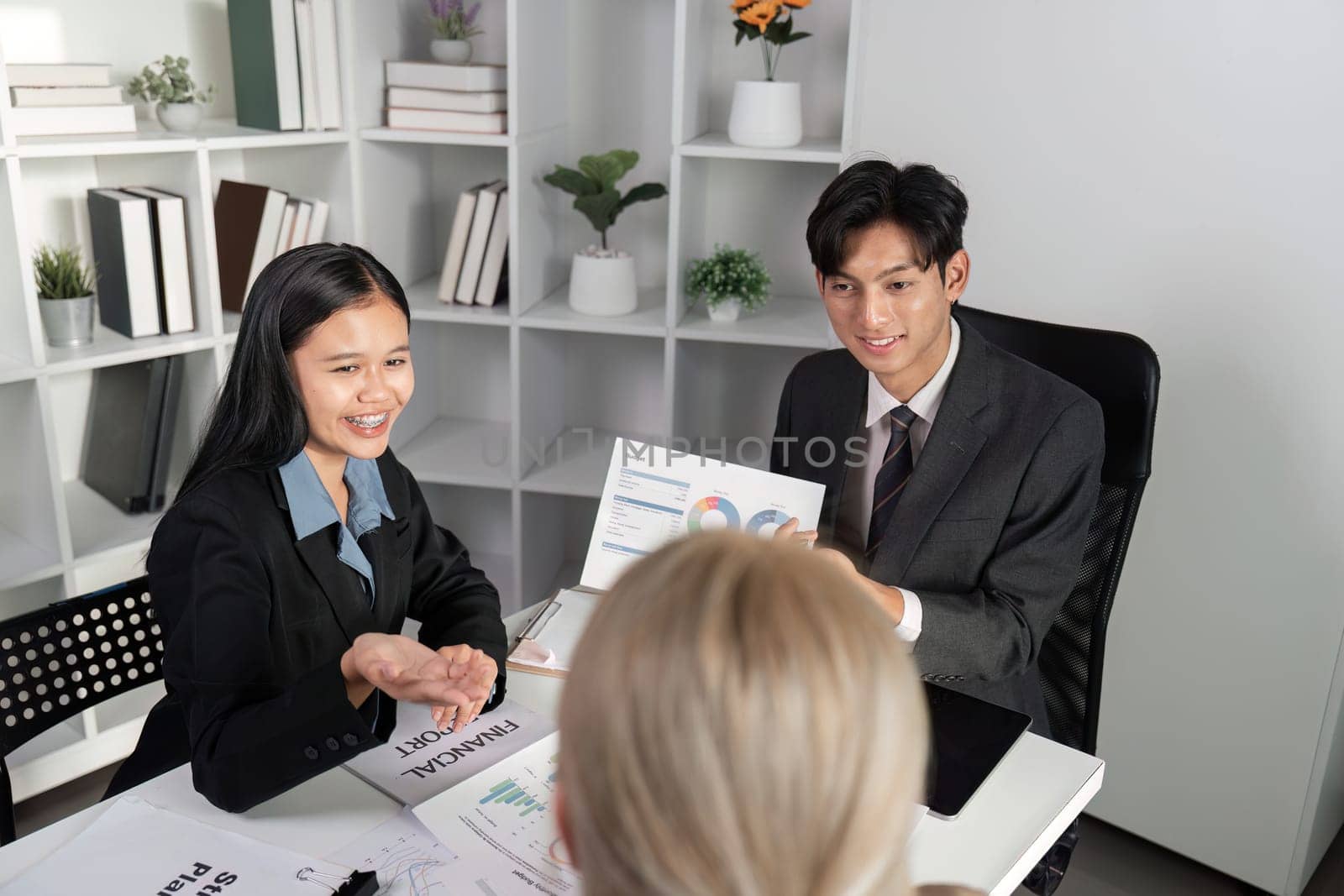 Business professionals in a meeting, exchanging ideas and collaborating in a modern office environment.
