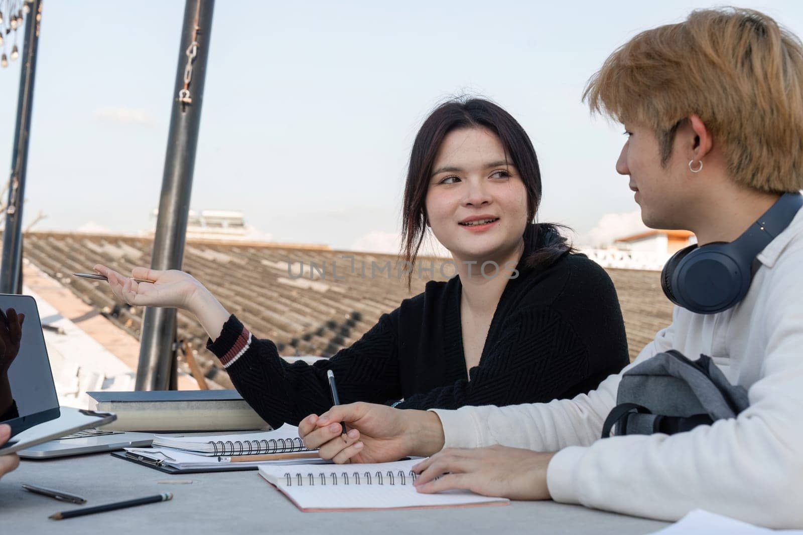 Teenagers gather after school to study and collaborate on assignments, fostering teamwork and learning in a casual environment.
