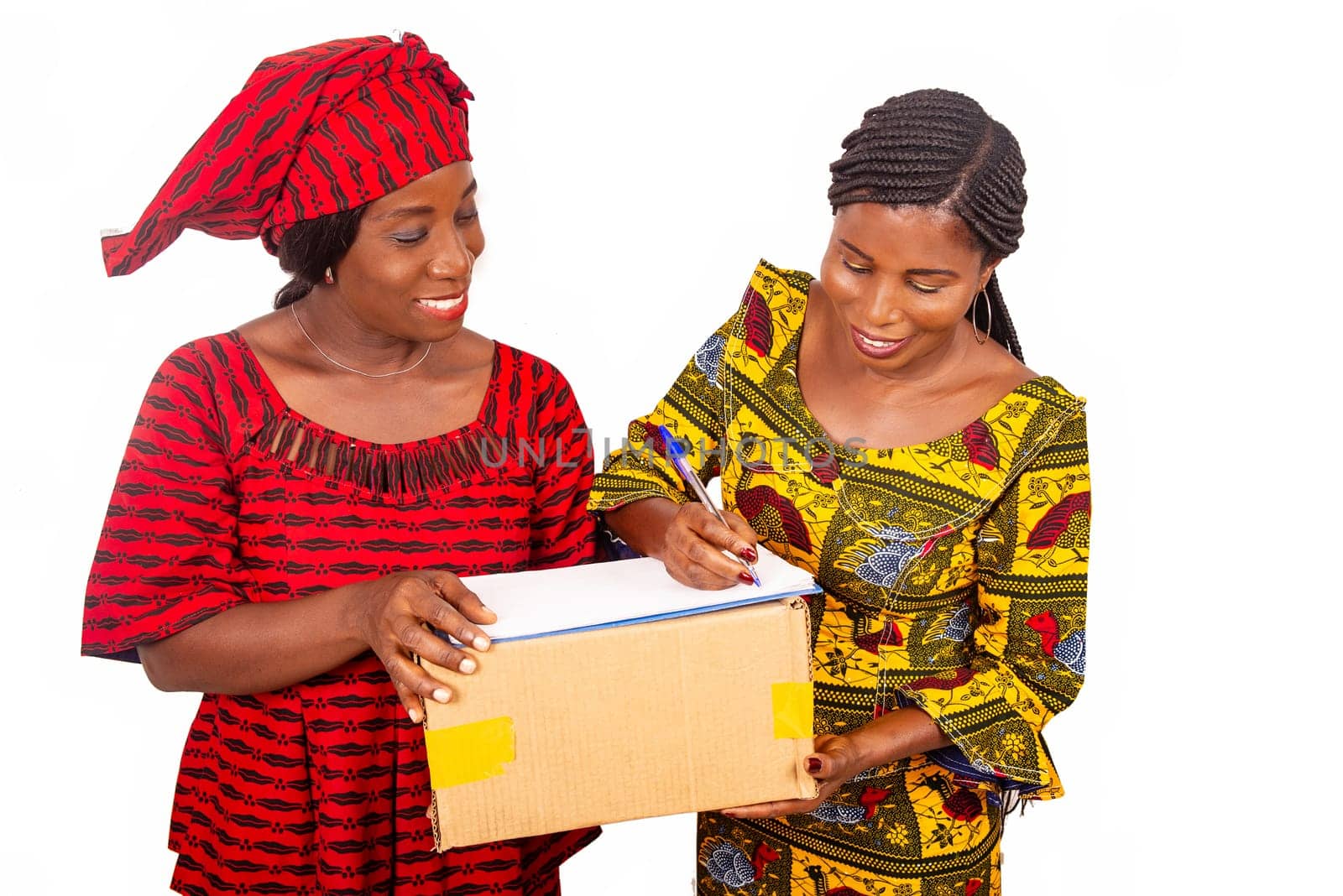 beautiful mature woman messenger carrying a large package and the business woman confirming receipt of delivery by signing
