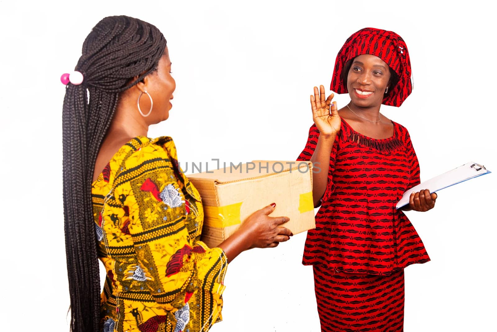 Adult business woman receiving a cardboard box of a woman dressed in red loincloth saying goodbye smiling with the help of a document