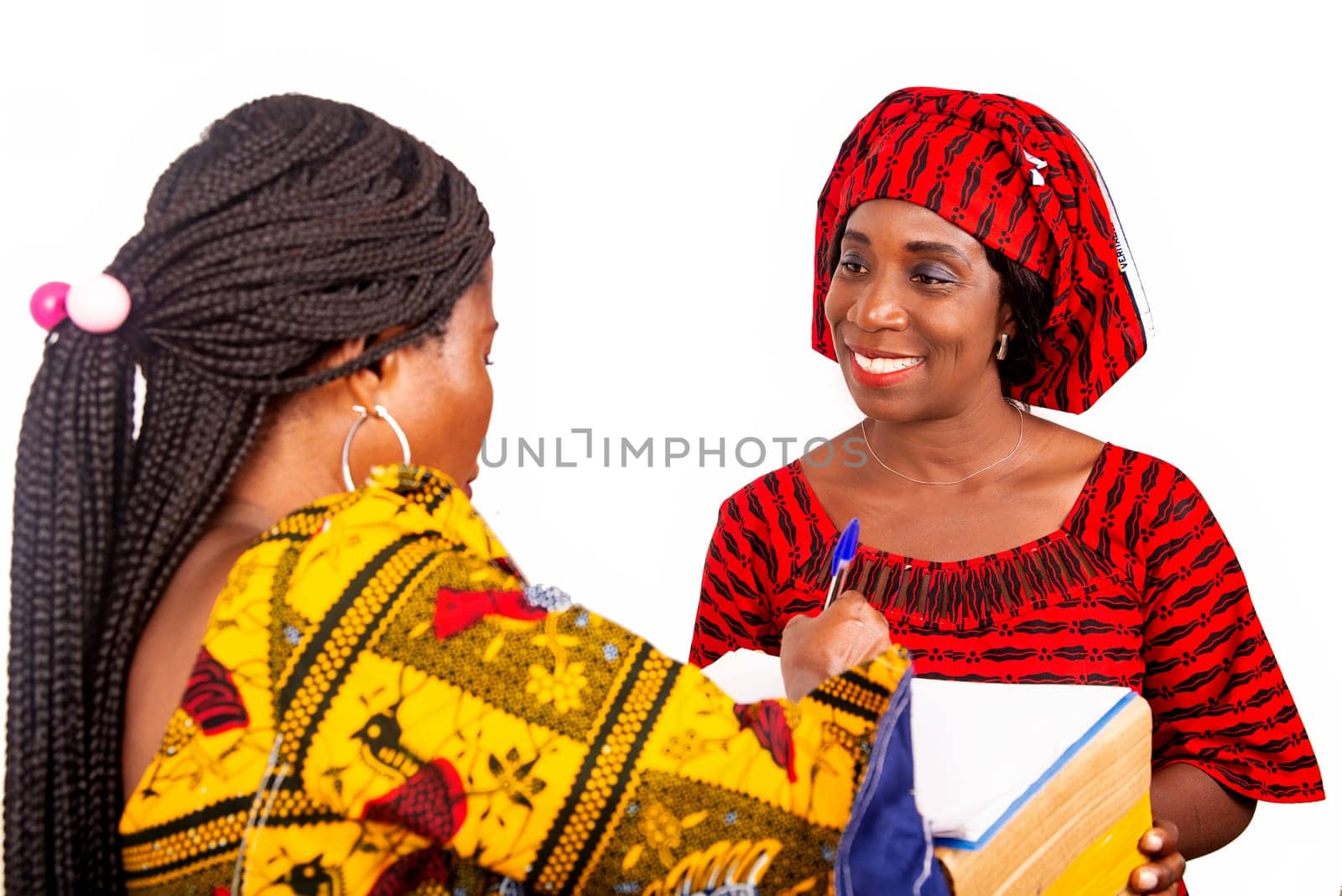beautiful mature woman messenger carrying a large package while the business woman confirming receipt of delivery by signing