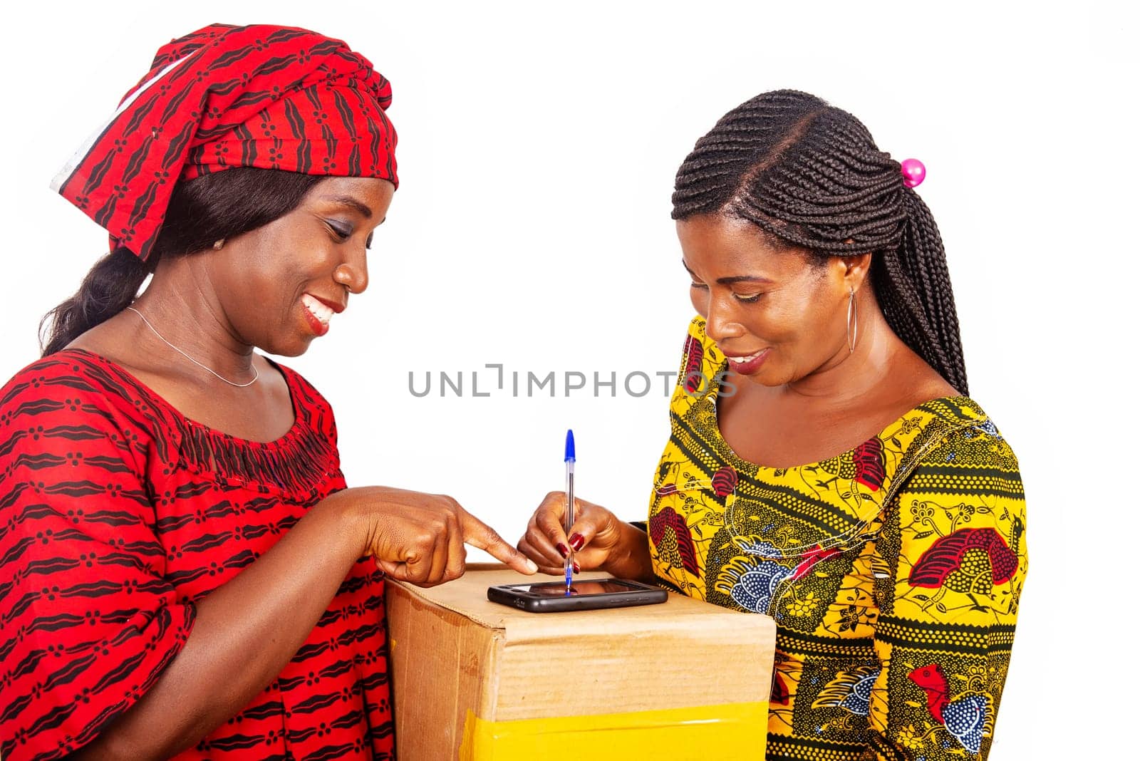 african adult woman client signing her digital mobile phone receiving parcel post office mail box with home delivery service adult woman in red loincloth at home