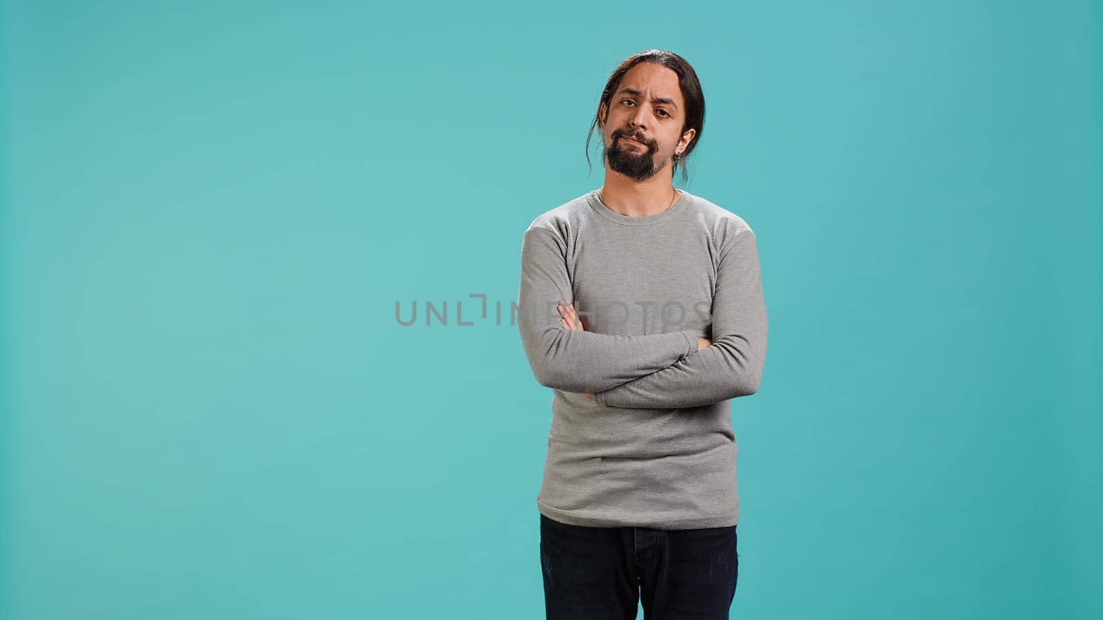 Man shakes head in disbelief, showing lack of satisfaction, isolated over studio background. Disappointed Arab person disagreeing with another person, studio backdrop, camera A