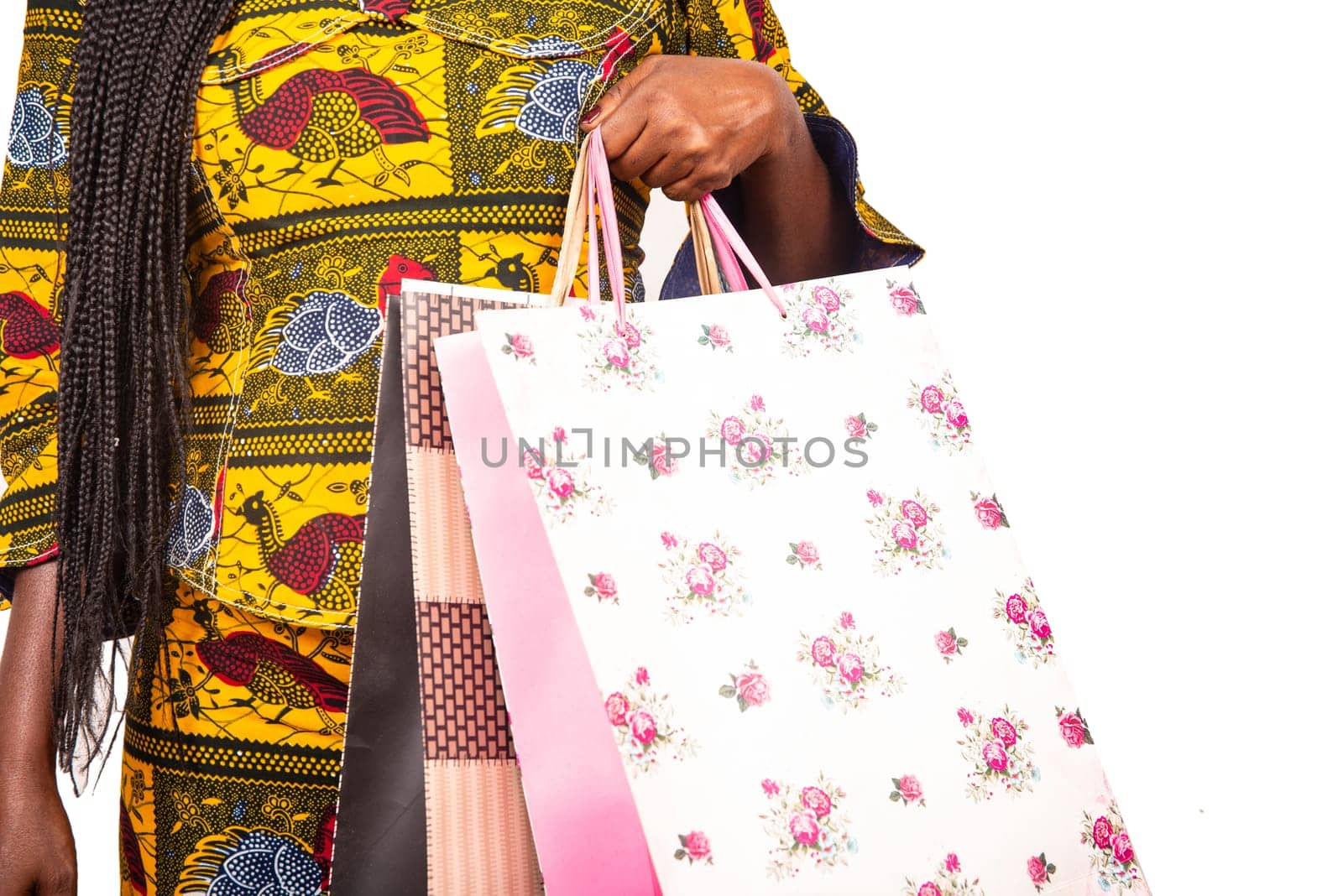 african adult woman holding colorful paper bags
