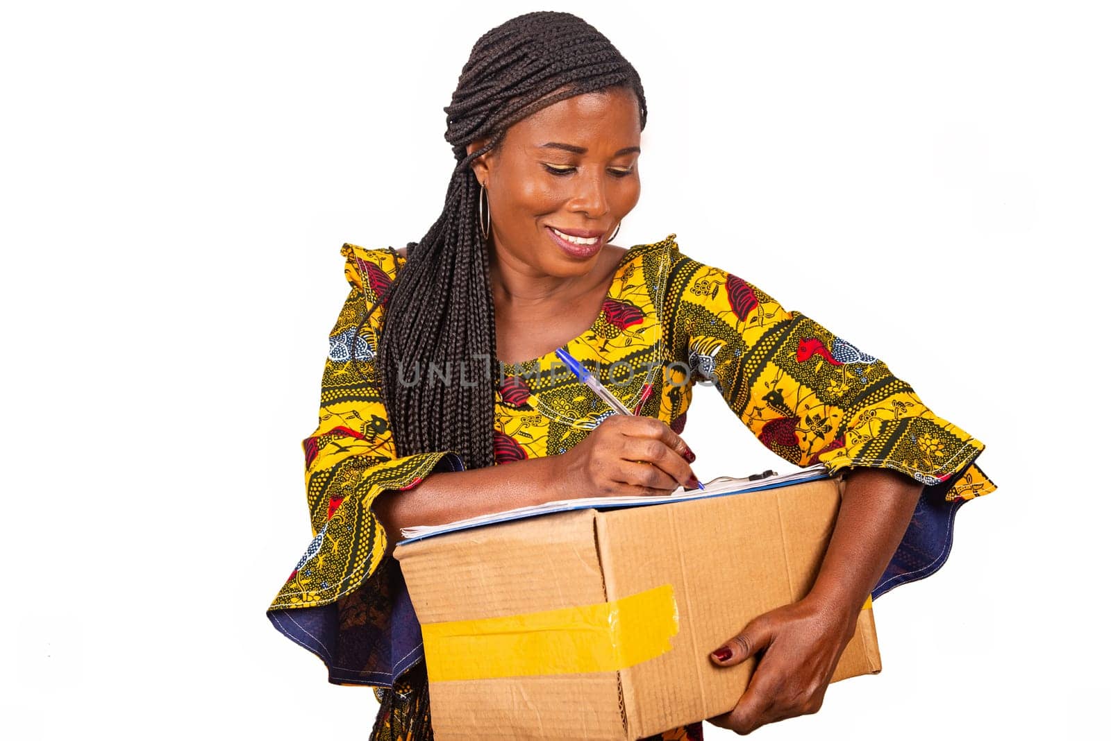 beautiful african woman standing in traditional dress on white background smiling to ask a signature.