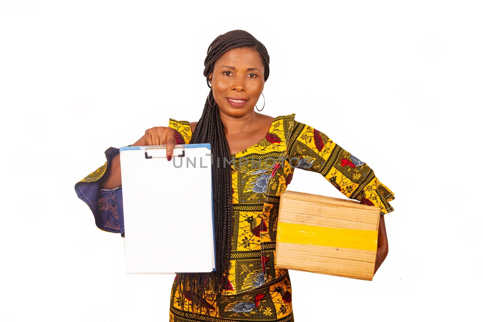 beautiful mature woman in traditional clothes standing on white background carrying a delivery package and document smiling.