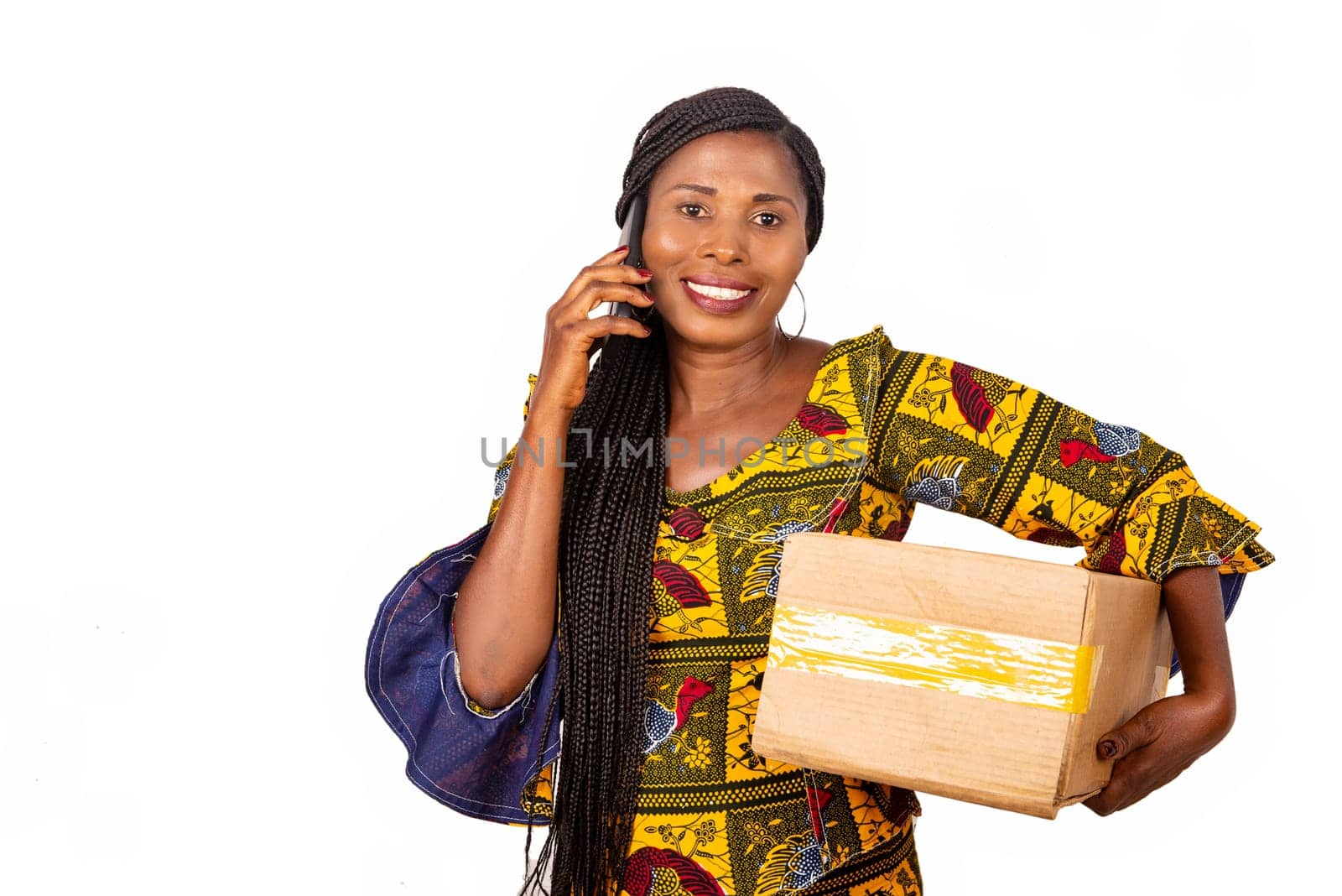 beautiful adult businesswoman talking on the mobile phone holding a cardboard