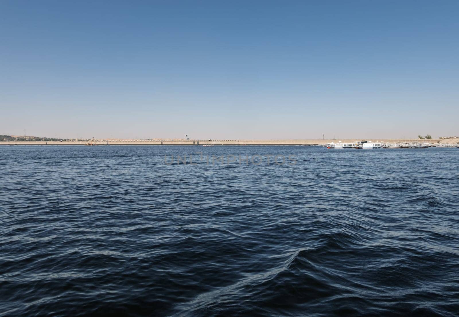 Panorama of Low Aswan Dam, or Old Aswan dam with tourboats used to transport tourists to Philae Temple