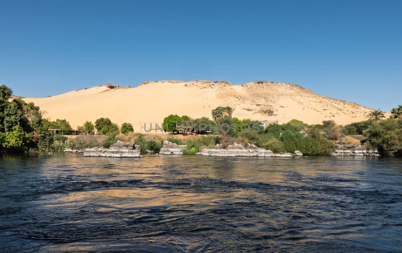 Granite rocks in the fast flowing water of the River Nile near Aswan Egypt