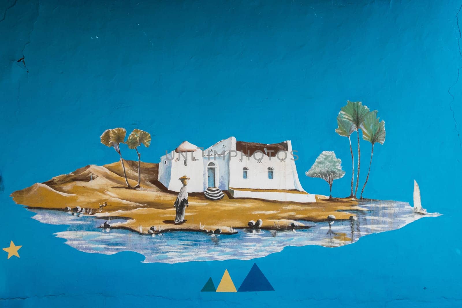 Aswan, Egypt - 5 November 2024: Traditional wall painting on Nubian home near the Nile River in Egypt