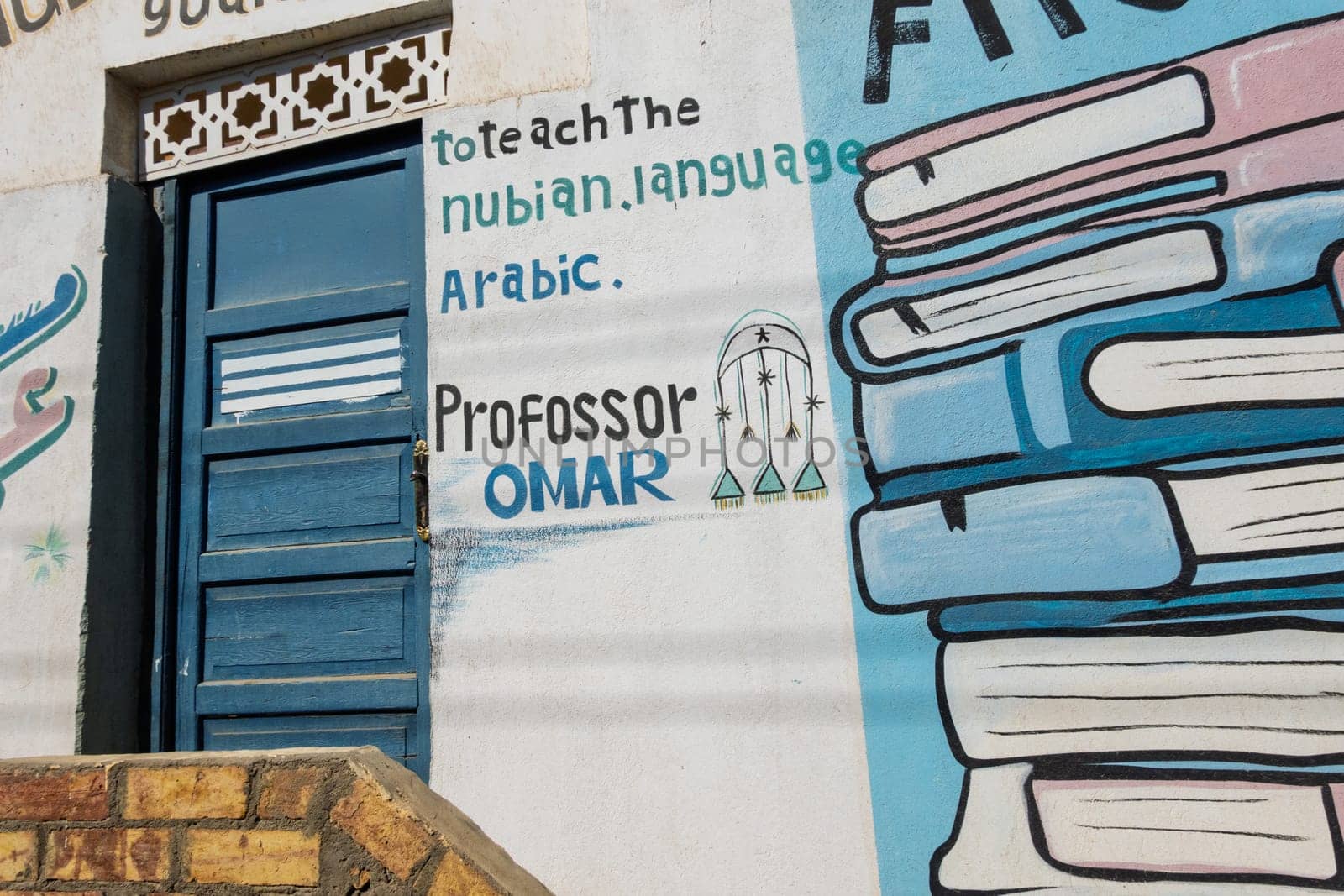 Aswan, Egypt - 5 November 2024: Traditional wall painting on Nubian home for professor or tutor in Arabic language