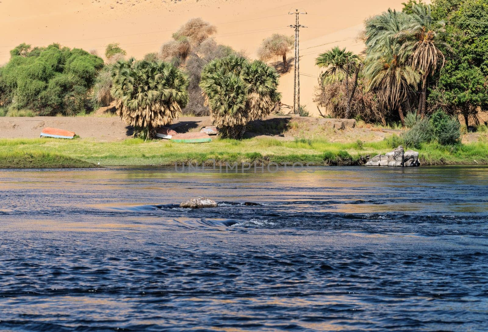 Granite rocks in the fast flowing water of the River Nile near Aswan Egypt