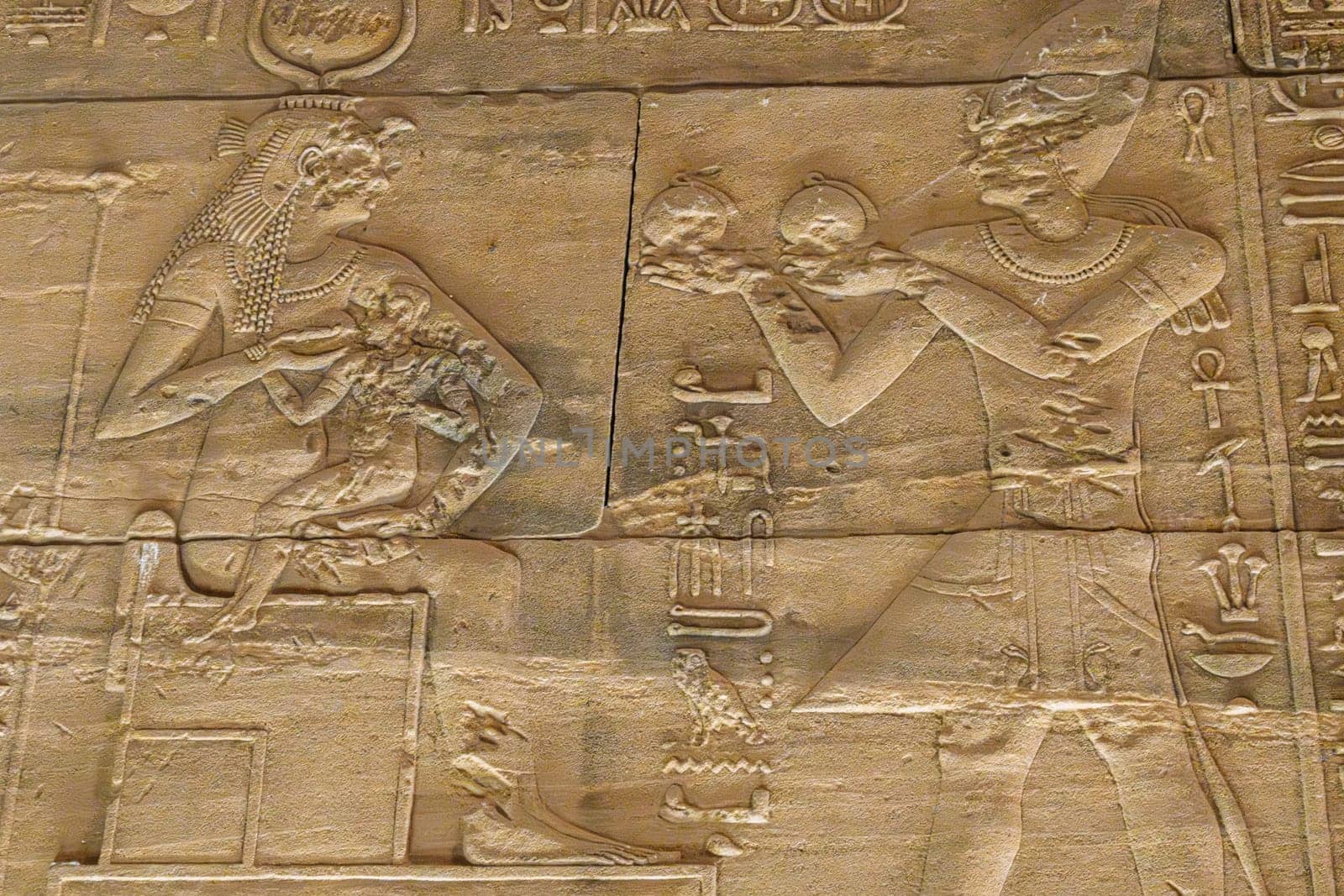 Detail of the bas-relief carving of the goddess Isis breastfeeding a baby pharoah in the Philae Temple in Aswan Harbor or Reservoir in Egypt