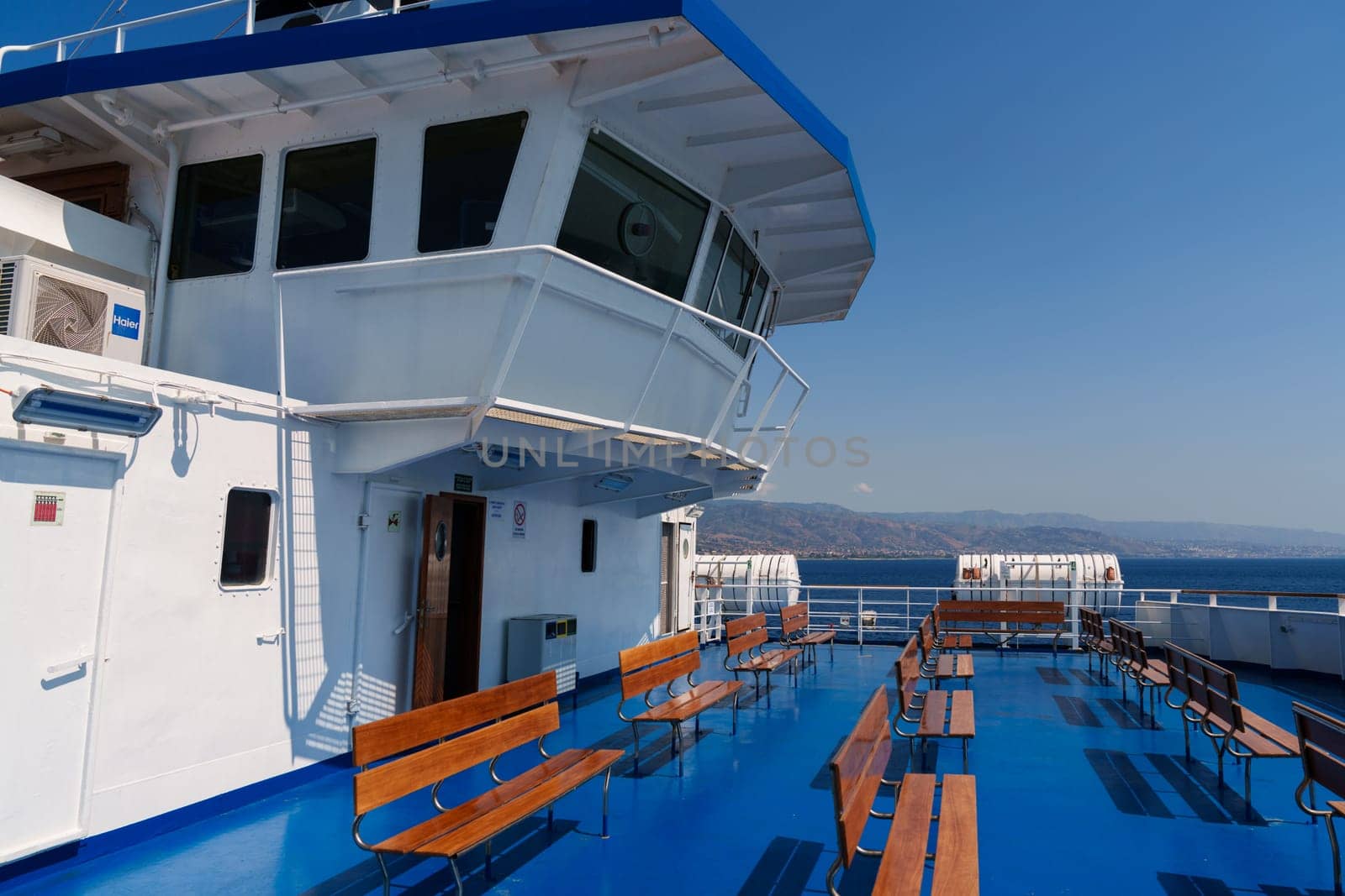 Sicily, Italy - 27.07.2024: Scenic deck view on passenger ferry crossing blue ocean.