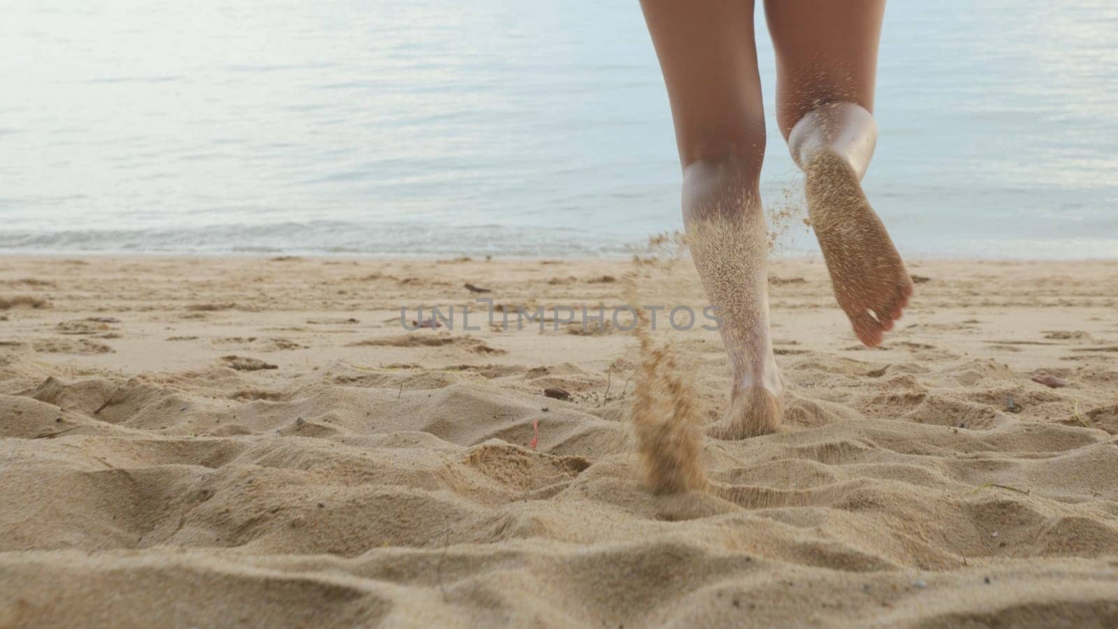 Back view, Young beautiful woman wearing bikini swimsuit running into tropical on sand beach to water, Happy Asian female have fun she run holiday outside, Summer travel vacation concept