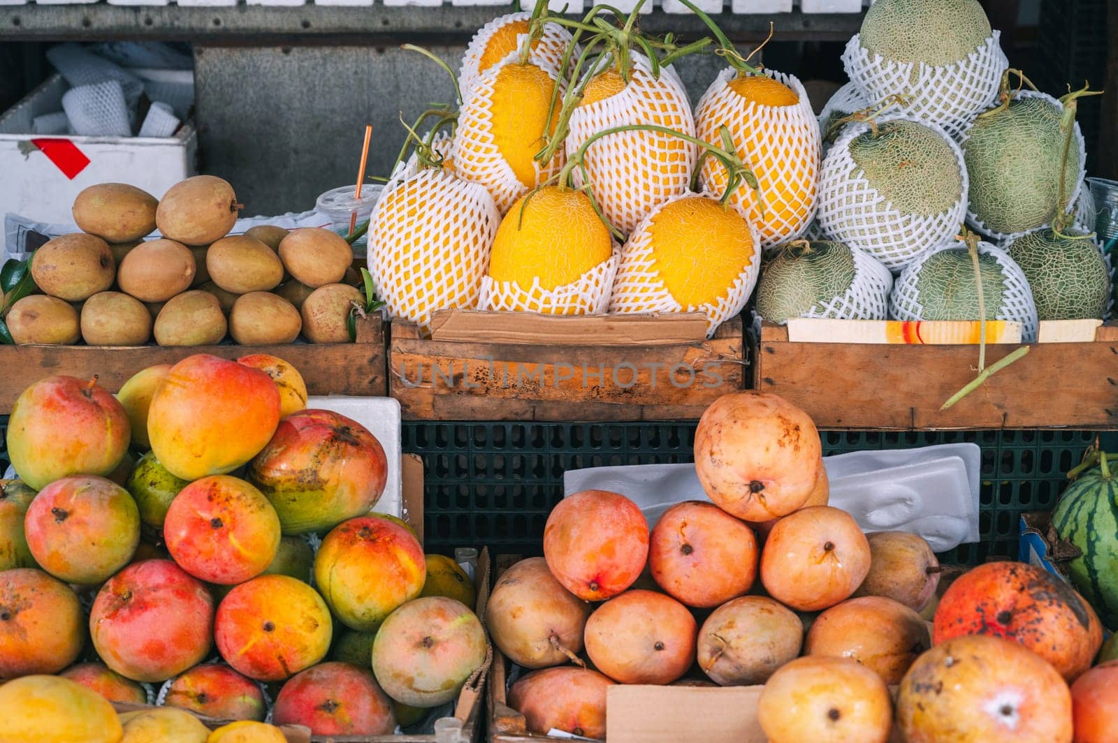 assortment of tropical fruits at the Asian food market in Asia in Vietnam. Mango and Vietnamese ripe sweet fruits
