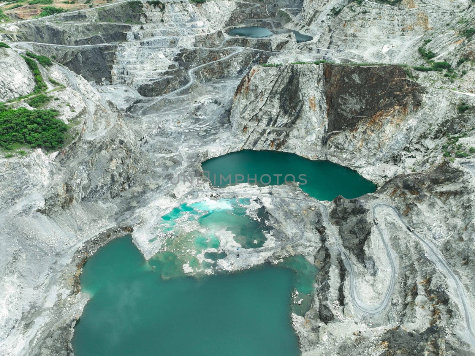 Open pit mine industry. Limestone quarry with backhoe and truck in operation. Heavy machinery in mining industry and construction material supply. Landscape of resource extraction in a industrial site