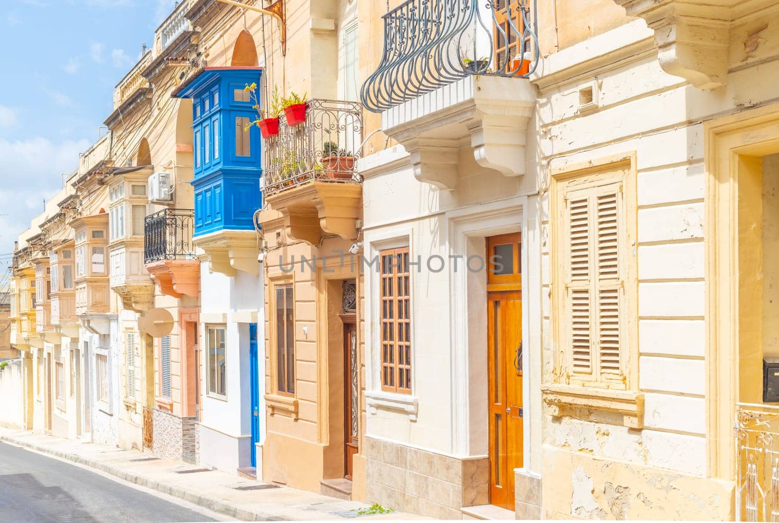 Typical Maltese street with old residential buildings in traditional architectural style, Malta.