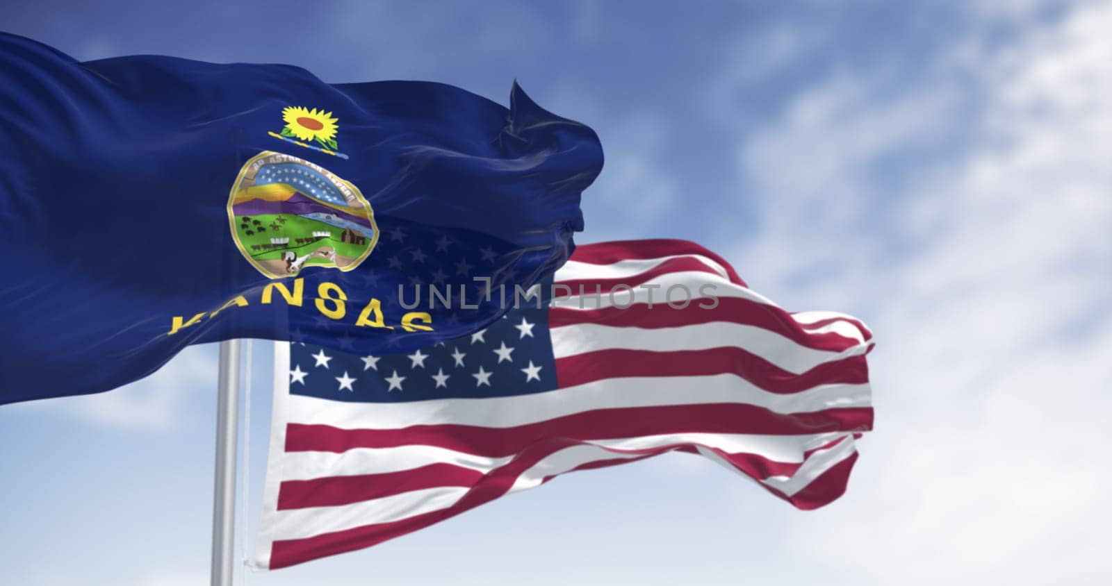 Close-up of Kansas state flag and American flag fluttering together in the wind under blue sky, symbolizing patriotism, democracy, unity, and freedom. Realistic 3D render with fabric texture.