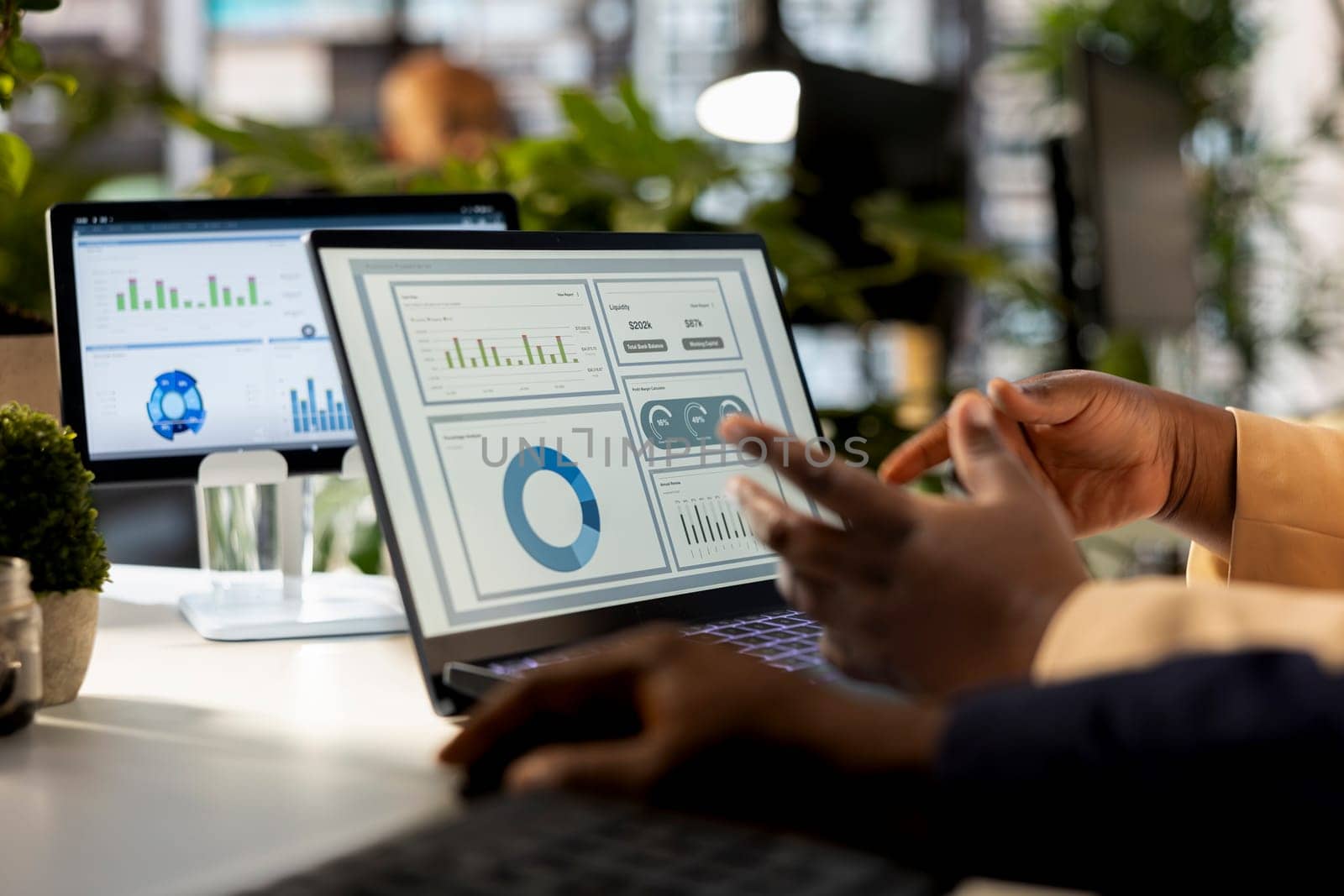 Business analyst meeting with a coworker to review financial report, leading a briefing presentation and exchanging ideas on enterprise development. Achieving goals for expansion.