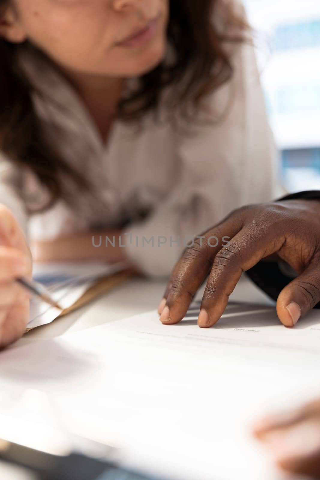 Team of investors calculating new financial projection plan to increase budget for the company expansion, finding ways to obtain more funds. Staff uses calculator for accounting analysis. Close up.