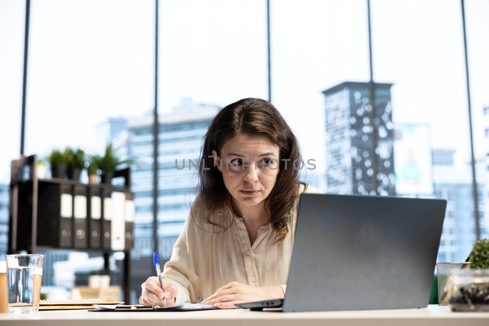 Entrepreneur with authority and executive power signing work contracts, solving her daily tasks of authorizing different requests from department employees. Jurisprudence paperwork.