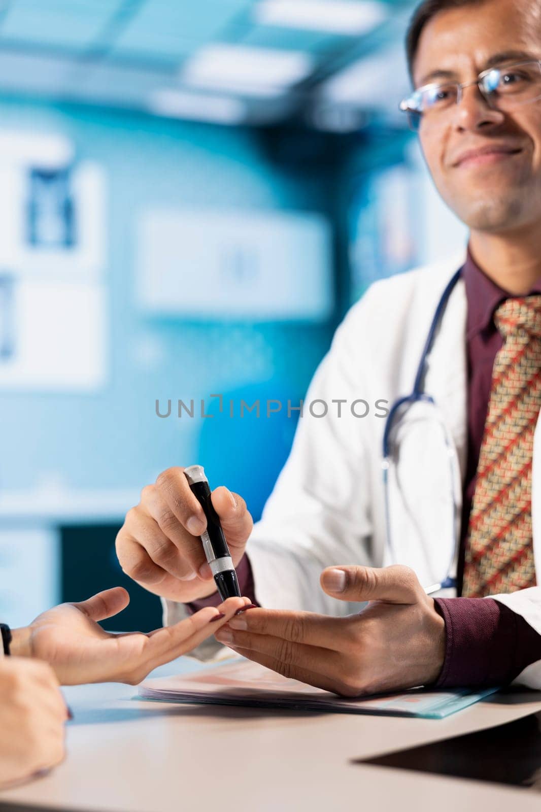 Indian physician prepares insulin pen for patient injection during a clinic visit, treating diabetes. Medic discusses disease diagnostic reports in a professional healthcare cabinet. Close up.