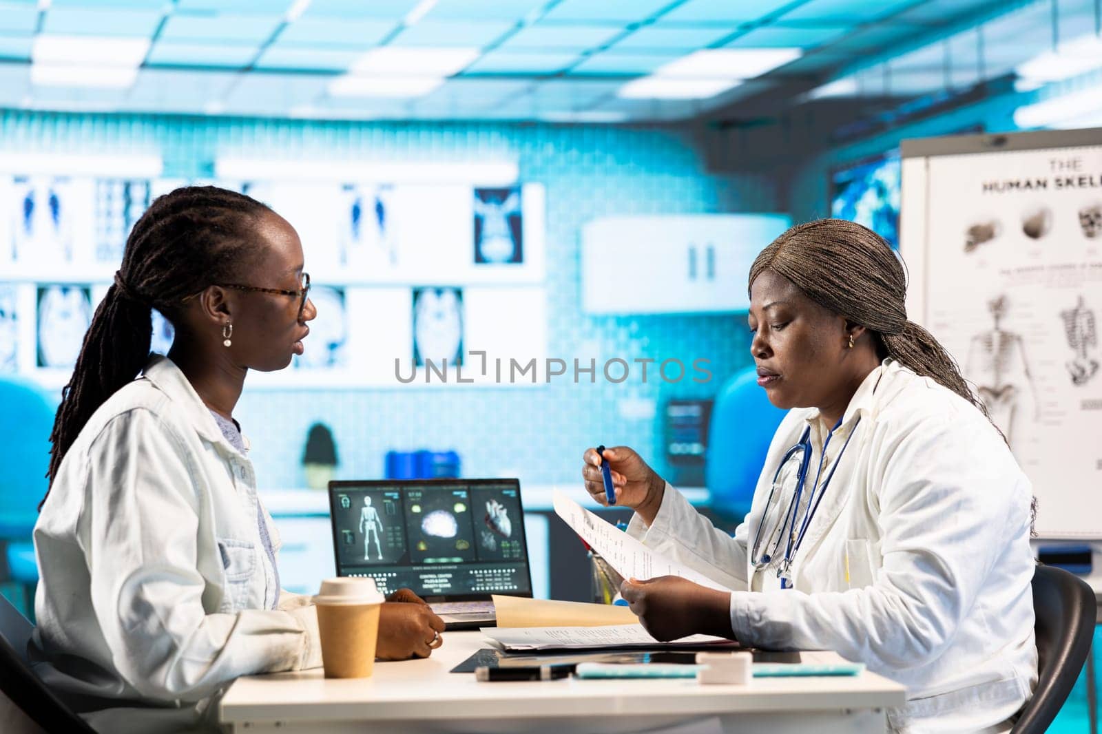 General practitioner prescribing antibiotics and vitamins on an insurance paper, recommending the right dosage for list of medicaments and painkillers. Medical drugs prescription.