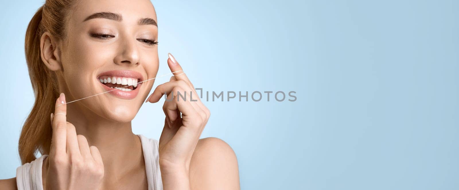 Dental Health Care. Woman Using Dental Floss Over Blue Background, Panorama with Free Space