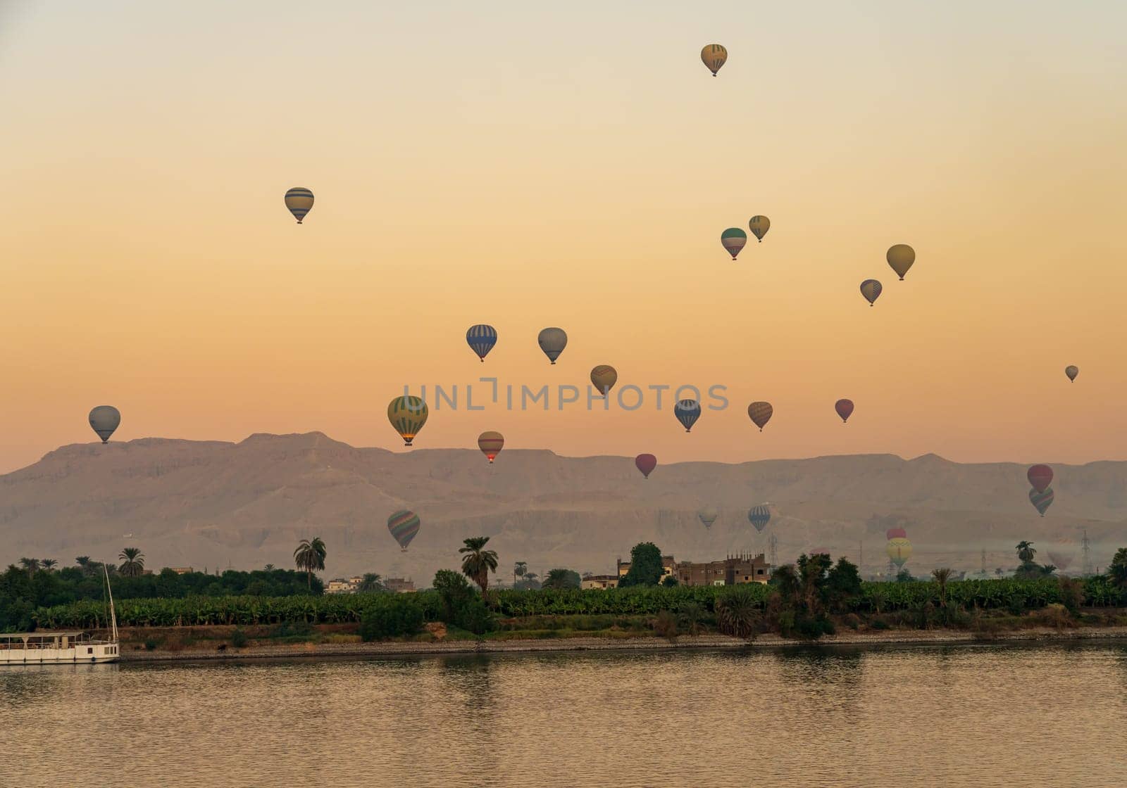 Many balloons in the sky over Nile River in Luxor for sunset flight over the Valley of the Kings