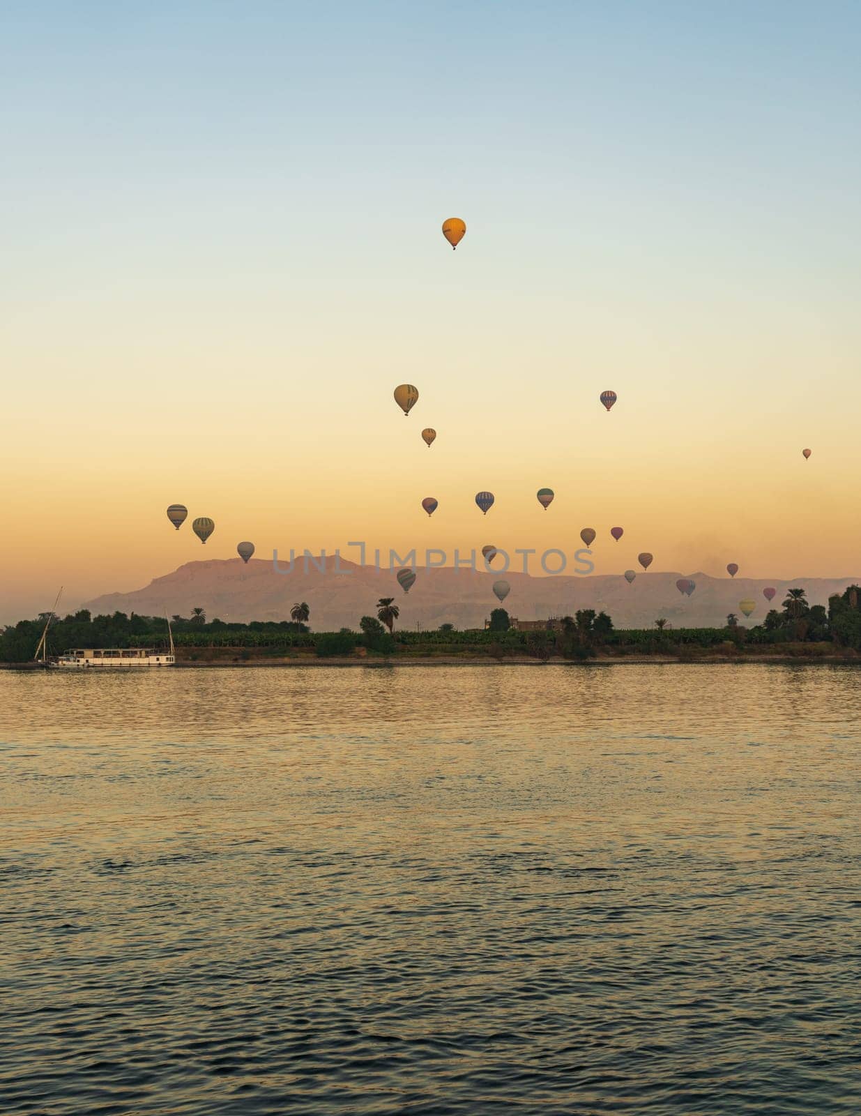 Many balloons in the sky over Nile River in Luxor for sunset flight over the Valley of the Kings